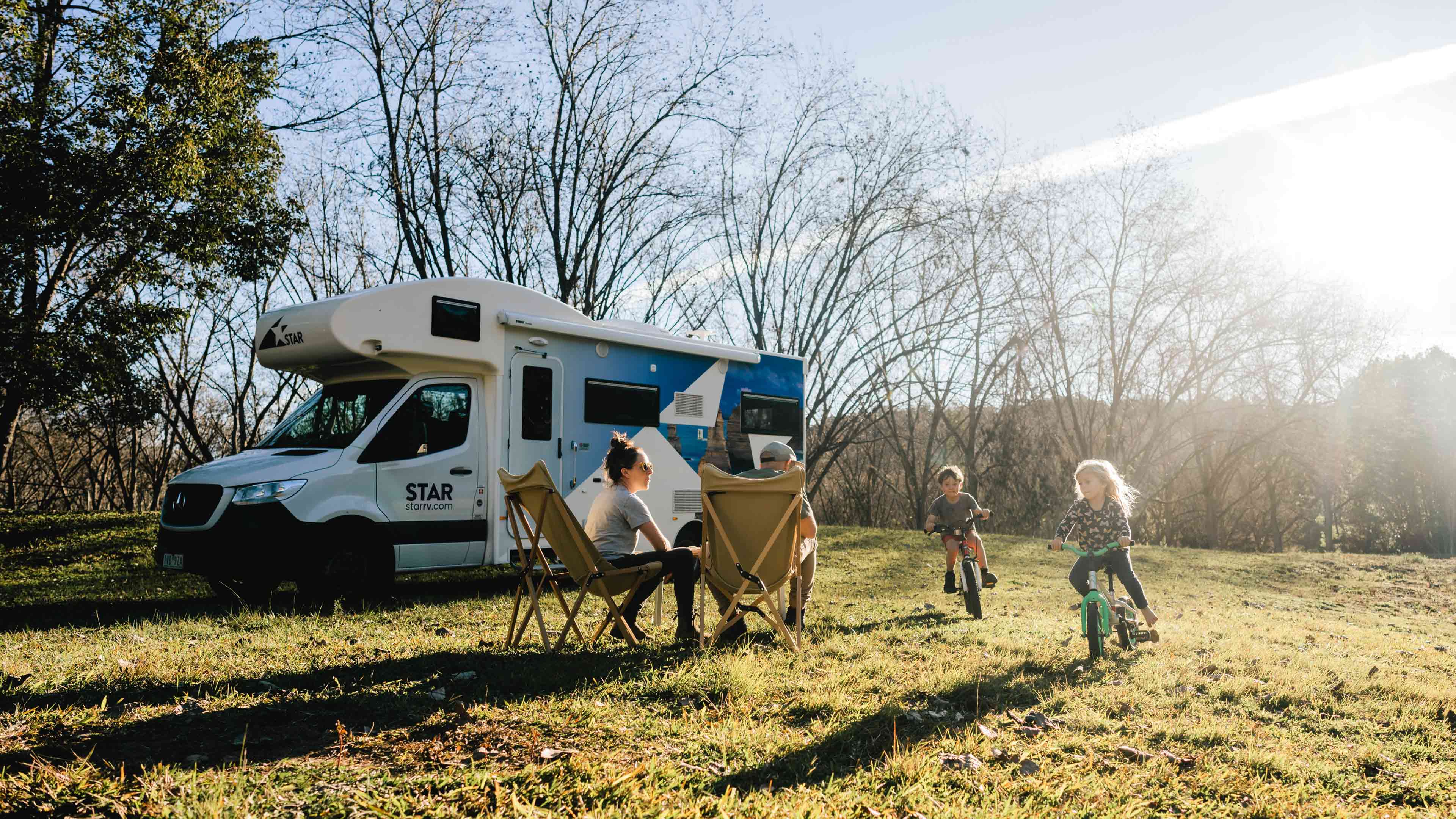 Children playing outside motorhome on bikes