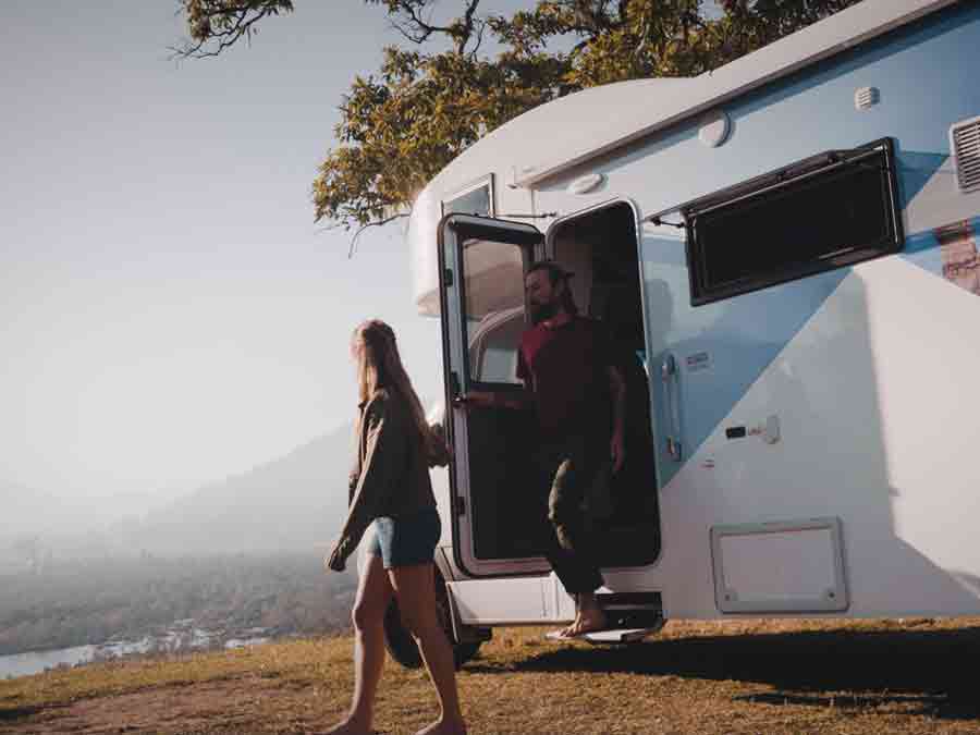 Couple stepping out of Star RV motorhome
