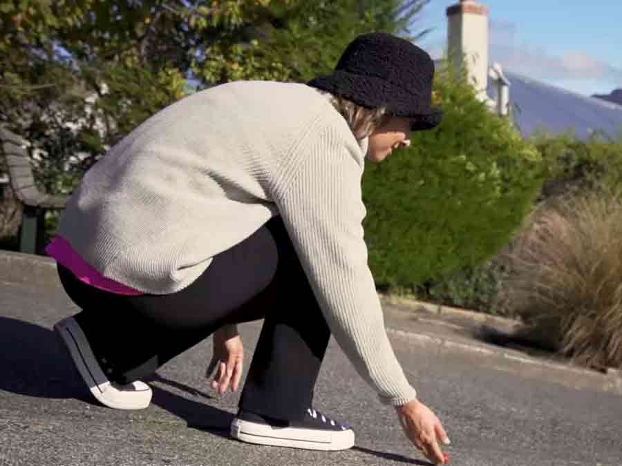 Girl rolling Jaffa down steepest street in the world
