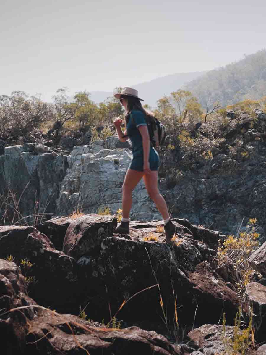Girl walking over rocks